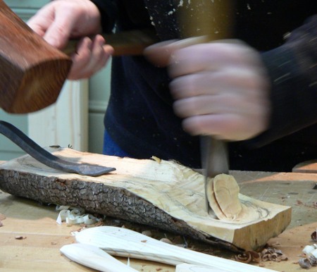 Carving the bowl of the spoon using a gouge and mallet